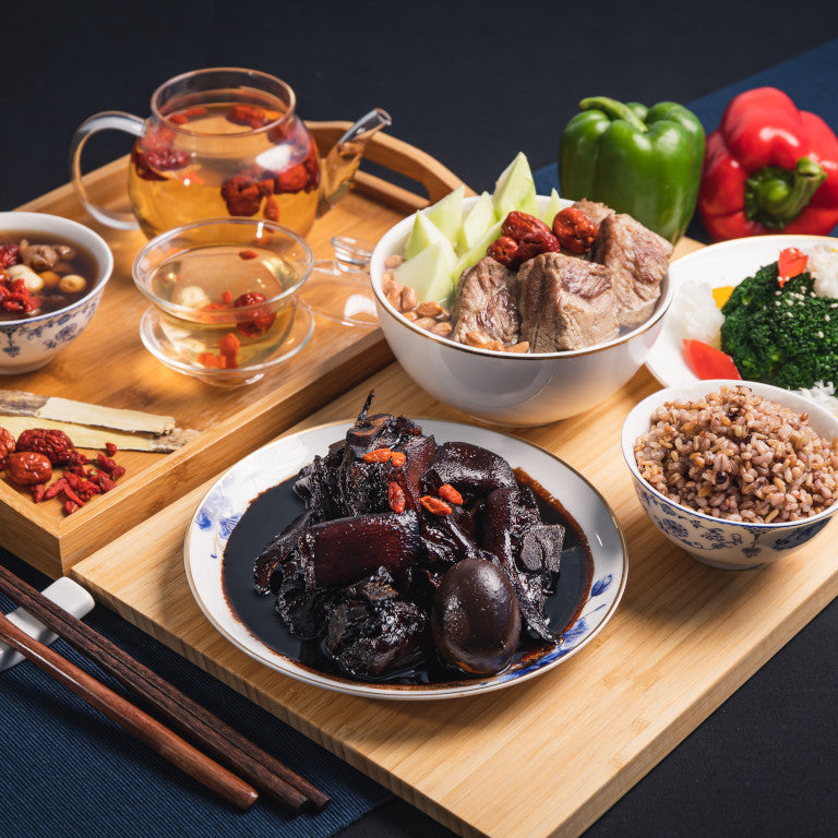 A variety of traditional Chinese postpartum meals arranged on a wooden table, including bowls of soup, rice, vegetables, and Herbal drinks.