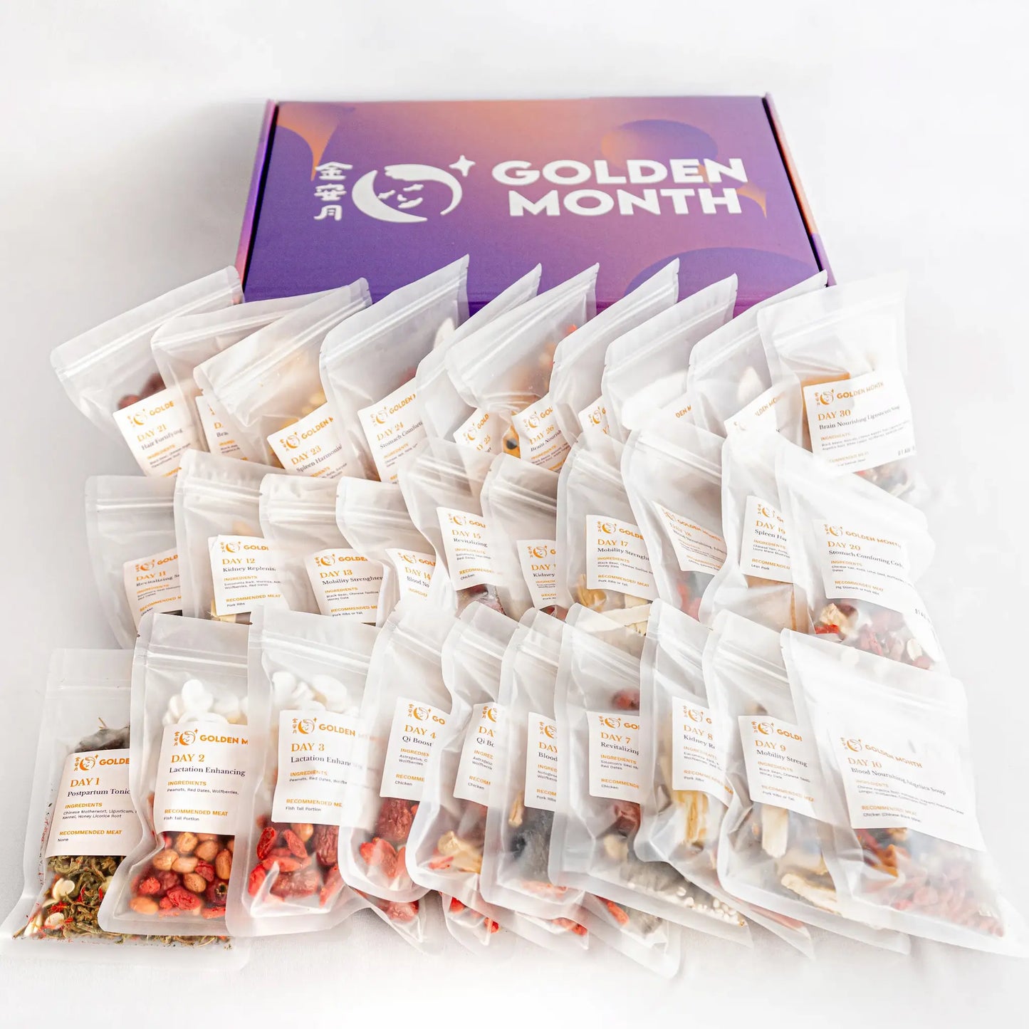 Multiple chinese postpartum soup packs in front of a 'Golden Month' branded box on a light gray background