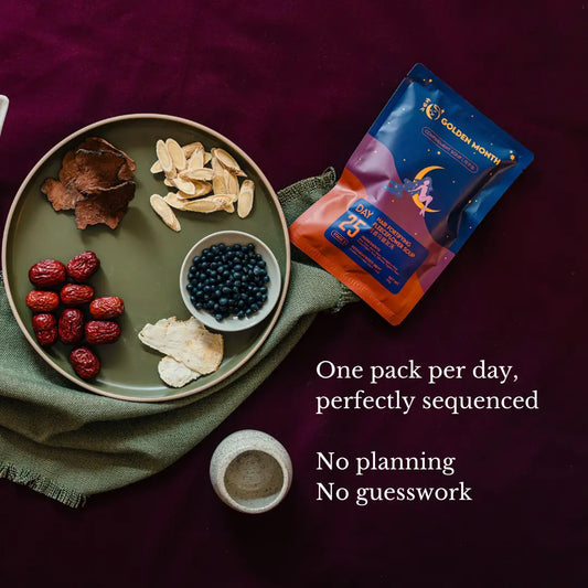 Supplement package with dried confinement herbs and nuts on a plate against a dark background