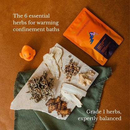 Herbs for warming confinement baths on a stone slab with packaging on a brown background