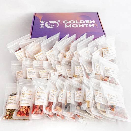 Multiple chinese postpartum soup packs in front of a 'Golden Month' branded box on a light gray background