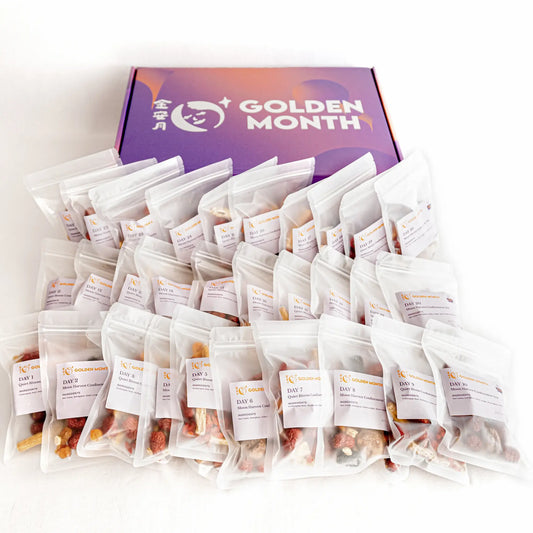 Multiple postpartum herbal tea packages in front of a purple box with 'Golden Month' branding on a white background