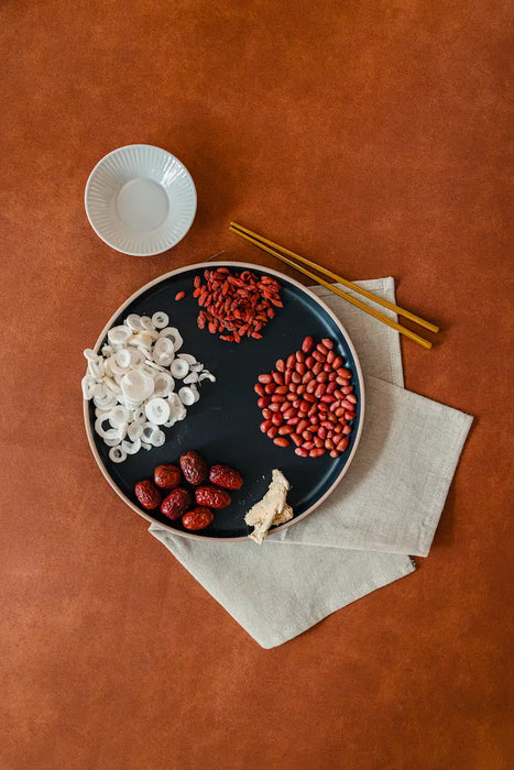 Plate with white and red herbs on a brown surface