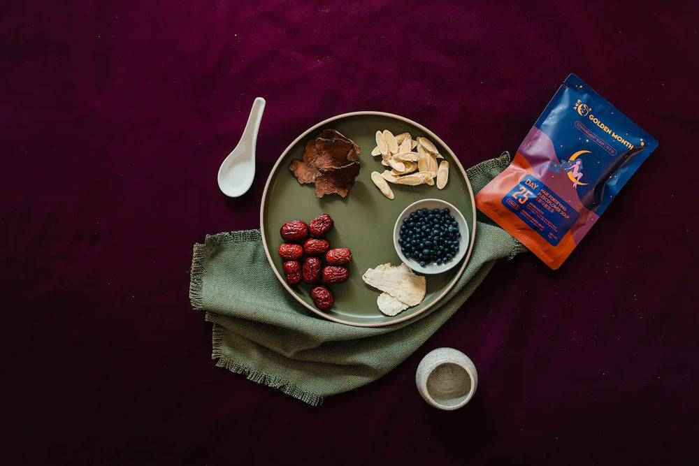 Herbal tea package with a plate of dried herbs and berries on a dark surface