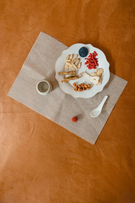 Dishes with confinement herbs on a brown surface