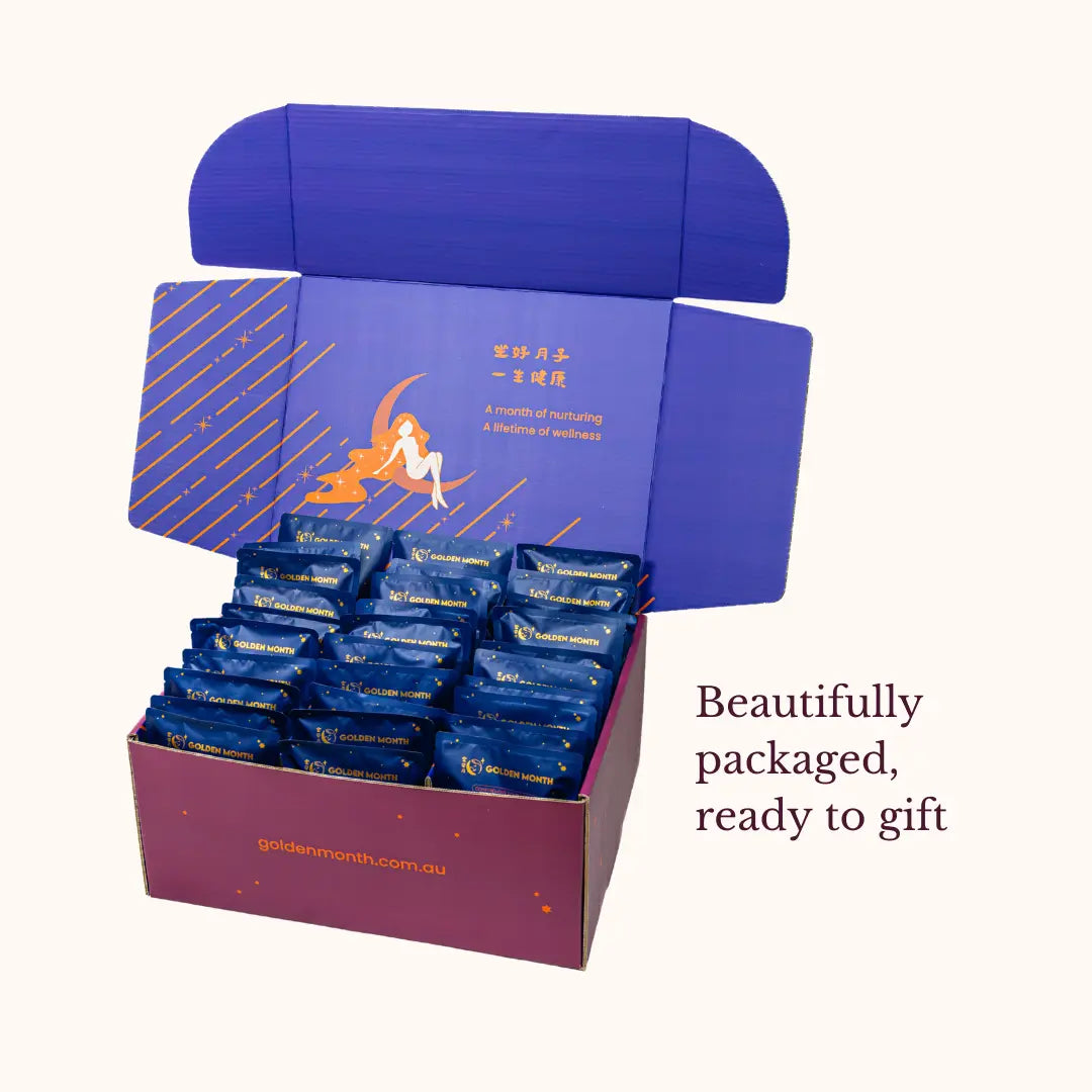 Open purple gift box with blue packages inside, featuring a decorative design on the lid.